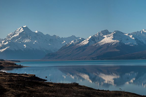 A mountain range in the distance with a lake in front of it